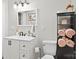 Well-lit bathroom with a white vanity, storage cabinet, and modern fixtures at 402 Sidney Johnson St, Fort Mill, SC 29715