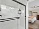 Elegant bathroom shower with marble-style tiles, black trim and a glass door at 402 Sidney Johnson St, Fort Mill, SC 29715