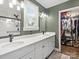 Stylish bathroom with dual sinks, modern fixtures, and walk-in closet at 402 Sidney Johnson St, Fort Mill, SC 29715