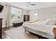 Inviting bedroom with neutral tones, large window, ceiling fan and ensuite bathroom at 402 Sidney Johnson St, Fort Mill, SC 29715