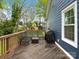 Deck with bench, table, and grill on back of house surrounded by green trees and grass at 402 Sidney Johnson St, Fort Mill, SC 29715