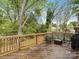 Spacious deck with a bench, coffee table, and grill, perfect for outdoor relaxation and entertaining at 402 Sidney Johnson St, Fort Mill, SC 29715
