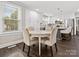 Dining area and kitchen with a round dining table and white cabinets at 402 Sidney Johnson St, Fort Mill, SC 29715
