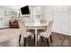 Dining area and living room with dark floors, stylish seating, and abundant natural light at 402 Sidney Johnson St, Fort Mill, SC 29715