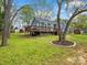 Exterior showcasing the rear of the home with a spacious deck and well-maintained yard with mature tree at 402 Sidney Johnson St, Fort Mill, SC 29715