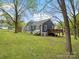 Back exterior of house featuring landscaped yard and wooden fence at 402 Sidney Johnson St, Fort Mill, SC 29715