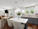 Modern kitchen featuring white cabinets, gray island, stainless steel appliances and breakfast nook at 402 Sidney Johnson St, Fort Mill, SC 29715