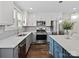 Bright kitchen featuring stainless steel appliances, gray cabinets, white countertops and wood floors at 402 Sidney Johnson St, Fort Mill, SC 29715