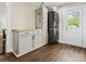 Clean laundry room featuring stackable washer/dryer, custom cabinetry and wood-look flooring at 402 Sidney Johnson St, Fort Mill, SC 29715