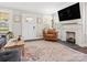 Bright living room with a decorative fireplace, stylish furniture and large flat screen TV at 402 Sidney Johnson St, Fort Mill, SC 29715