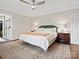 Spacious main bedroom with neutral color scheme, ceiling fan, ensuite bathroom and large rug at 402 Sidney Johnson St, Fort Mill, SC 29715
