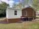Backyard of a brick home featuring a white room addition at 430 Coolidge Ave, Statesville, NC 28677