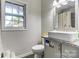 Bathroom with a vessel sink, toilet, and window at 430 Coolidge Ave, Statesville, NC 28677