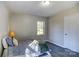 Bedroom with a twin bed, window, and hardwood style flooring at 430 Coolidge Ave, Statesville, NC 28677