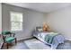 Bedroom with a twin bed, chair, and window allowing natural light to flow in at 430 Coolidge Ave, Statesville, NC 28677