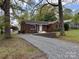 Brick home featuring a gravel driveway and landscaped front yard providing attractive curb appeal at 430 Coolidge Ave, Statesville, NC 28677