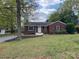 Charming single-story brick home with landscaped front yard and manicured lawn at 430 Coolidge Ave, Statesville, NC 28677