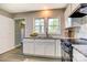Modern kitchen with stainless steel appliances, granite countertops, and natural light from two windows at 430 Coolidge Ave, Statesville, NC 28677
