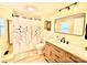 Renovated bathroom features wood cabinets, modern lights and new fixtures at 45 Oak St, Great Falls, SC 29055