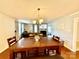 Dining area with wood table, wood flooring, and view into adjacent living room with tv and fireplace at 45 Oak St, Great Falls, SC 29055
