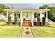 Charming home featuring a cozy front porch with rocking chairs and beautiful landscaping at 45 Oak St, Great Falls, SC 29055