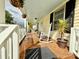 Picturesque porch with rocking chairs, plants and neutral toned exterior at 45 Oak St, Great Falls, SC 29055