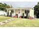 Attractive home with a welcoming front porch, featuring a lovely brick walkway and garden details at 45 Oak St, Great Falls, SC 29055