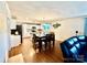 Open concept kitchen and dining area with a dining table, an island, and white cabinets at 45 Oak St, Great Falls, SC 29055
