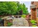 The backyard features a stone patio with a built in stone grill, a sitting area, and a fire pit at 4711 Pearmain Dr, Waxhaw, NC 28173