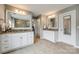 Bathroom with dual sink granite vanity, tile flooring, and bright white cabinetry at 4711 Pearmain Dr, Waxhaw, NC 28173
