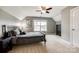 Comfortable bedroom with natural light, ceiling fan, and neutral tones offers a peaceful retreat at 4711 Pearmain Dr, Waxhaw, NC 28173