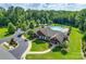 Aerial view of a clubhouse with a pool, ample parking, landscaping and green space at 4711 Pearmain Dr, Waxhaw, NC 28173