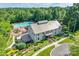 Aerial view of a large community pool and clubhouse with playground, and lots of lush trees at 4711 Pearmain Dr, Waxhaw, NC 28173