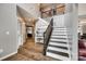 A grand foyer featuring wood floors, soaring ceilings, an elegant staircase, and stylish decor at 4711 Pearmain Dr, Waxhaw, NC 28173