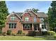 Beautiful brick home with meticulously maintained lawn and front porch seating at 4711 Pearmain Dr, Waxhaw, NC 28173