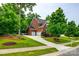 Traditional two-story brick home featuring a three-car garage and well-manicured front yard at 4711 Pearmain Dr, Waxhaw, NC 28173