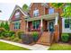 A welcoming brick-lined porch with red chairs, offering a relaxing outdoor space with manicured landscaping at 4711 Pearmain Dr, Waxhaw, NC 28173