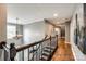 Upstairs hallway with hardwood floors, decorative lighting, and a staircase at 4711 Pearmain Dr, Waxhaw, NC 28173