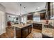 Open kitchen features granite countertops, stainless steel appliances and seamless flow to adjacent living spaces at 4711 Pearmain Dr, Waxhaw, NC 28173