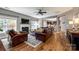Cozy living room features a fireplace, hardwood floors, and comfortable leather seating at 4711 Pearmain Dr, Waxhaw, NC 28173