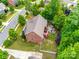 Aerial view of a two-story brick home featuring a deck and stone patio with firepit at 4711 Pearmain Dr, Waxhaw, NC 28173