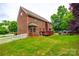 Two-story brick home with deck, stone firepit area, and well-manicured lawn at 4711 Pearmain Dr, Waxhaw, NC 28173