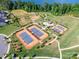 Aerial shot of community tennis courts, dog park, walking trails, and pavilion at 529 Cellini Pl # 243, Mount Holly, NC 28120