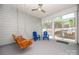 Enclosed back porch featuring two Adirondack chairs and a wooden porch swing at 529 Cellini Pl # 243, Mount Holly, NC 28120