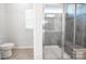 Spacious tile shower featuring glass doors and a built-in seat, set within a bright, neutral-toned bathroom at 529 Cellini Pl # 243, Mount Holly, NC 28120