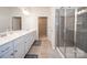 Clean, bright bathroom with double vanity, walk-in shower, and tile floors at 529 Cellini Pl # 243, Mount Holly, NC 28120