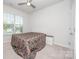 Minimalist bedroom with neutral tones, plush carpeting, natural light, and a comfortable bed at 529 Cellini Pl # 243, Mount Holly, NC 28120
