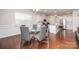 Dining area with modern chairs, a glass table, hardwood floors, and an open view to the kitchen at 529 Cellini Pl # 243, Mount Holly, NC 28120