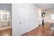 Bright hallway leading to a bathroom, living room with fireplace, and beautiful hardwood flooring at 529 Cellini Pl # 243, Mount Holly, NC 28120