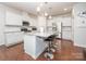 Modern kitchen with white cabinets, stainless steel appliances, and a large island with bar stools at 529 Cellini Pl # 243, Mount Holly, NC 28120